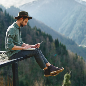 A man working remotely from the mountains.